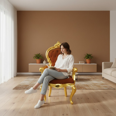 Elegante Barockstull am originale orangefaarwege Faarftoun mat glänzende gëllfaarwege Stëtzen.