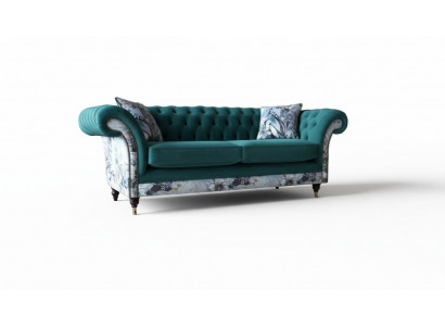 Een liewegt Tressëtz-Sofa aus Chesterfield an engem zarten Smaragdgréng mat Blummenmuster.